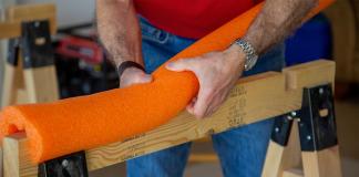 “Today’s Homeowner” Simple Solutions host Joe Truini wraps an orange pool noodle around a saw horse before painting his interior door