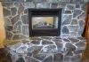 Rock fireplace with dark mortar in living room