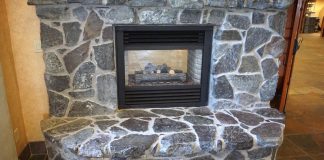 Rock fireplace with dark mortar in living room