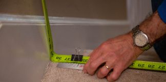 Measuring tape with card clipped with binder