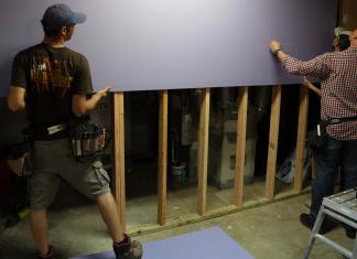 “Today’s Homeowner” host Danny Lipford installs Purple drywall with another man in a Georgia basement