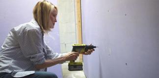 Woman installs National Gypsum's SoundBreak XP drywall at her Georgia townhome.