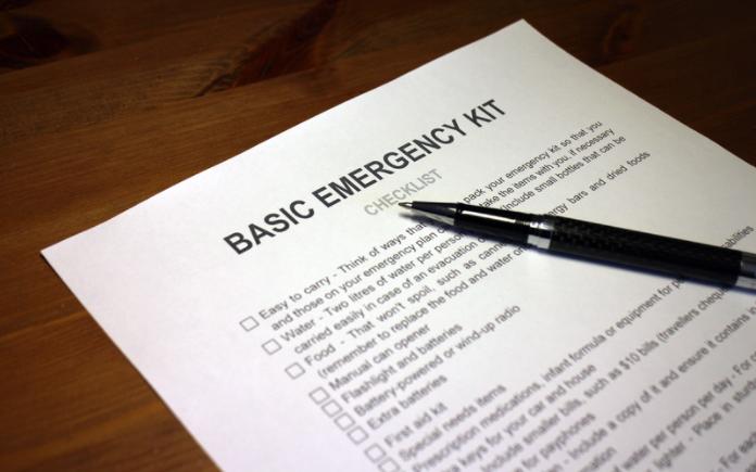 Basic emergency checklist on paper with pen