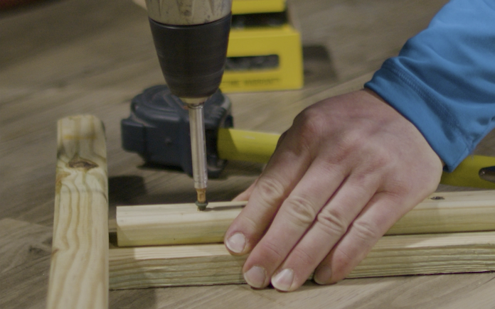 Drilling a screw into pressure-treated wood