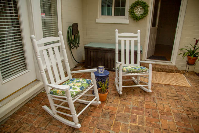 Two rocking chairs on a brick paver patio