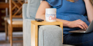 sofa arm tray on a couch arm with checking in with chelsea mug