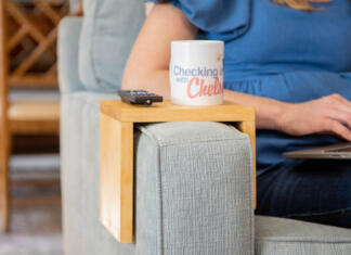 sofa arm tray on a couch arm with checking in with chelsea mug