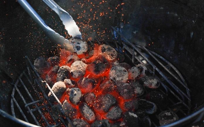 metal tongs pick up hot charcoal