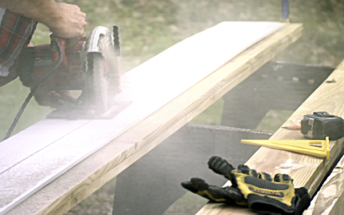 Sawing fiber cement siding on a sawhorse