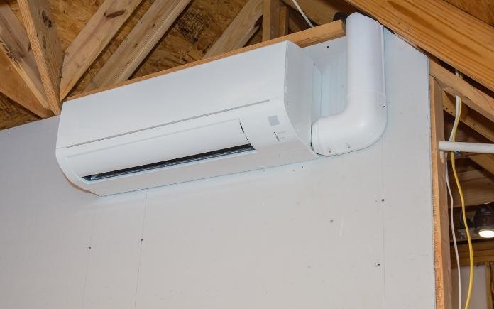 mini-split ductless air conditioning unit installed in unfinished room