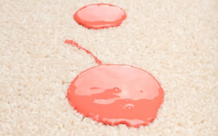 Paint droplets on a beige carpet