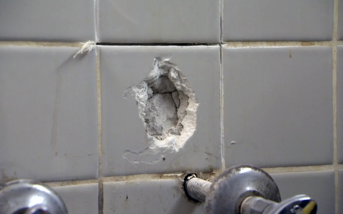 A hole in ceramic wall tile. 
