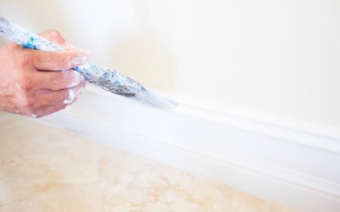 Hand painting wall trim with a paintbrush