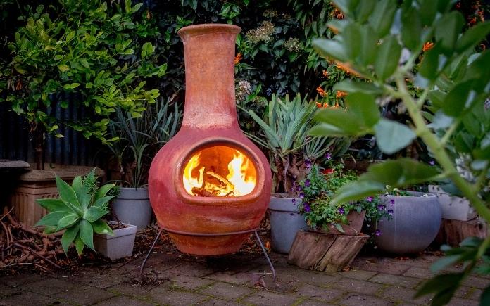 The fire is burning in the clay chiminea