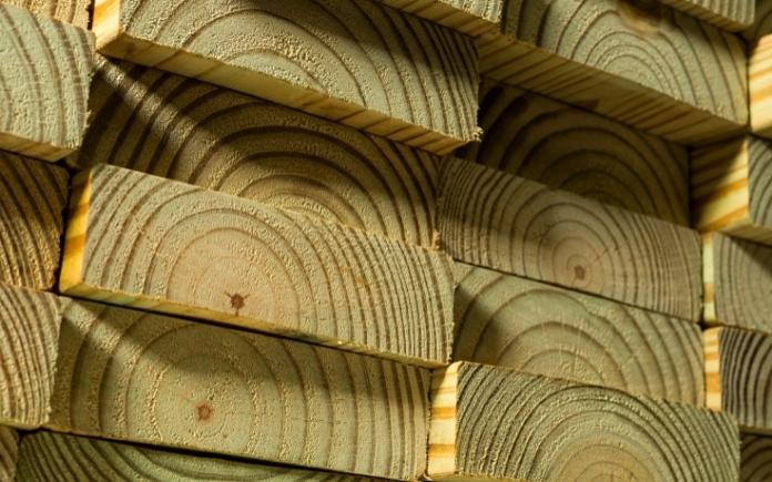 Stacks of pressure-treated lumber boards