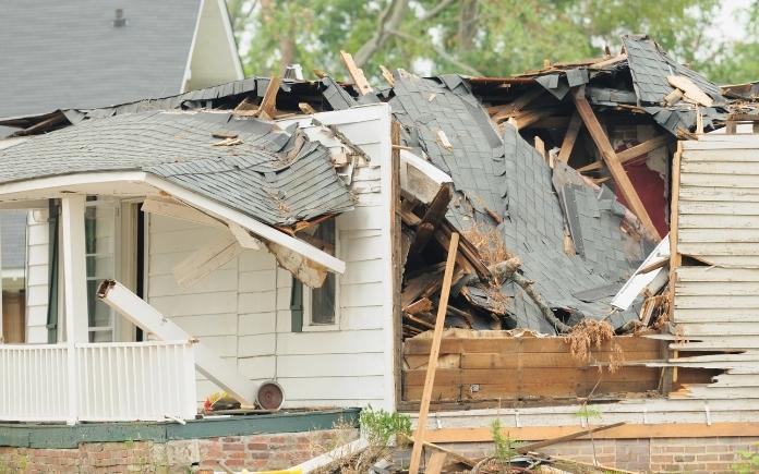 Tornado damaged home with collapsed roof