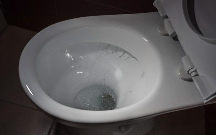 Water flushing in toilet