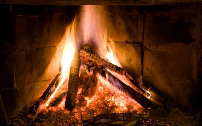 wood burning in a brick fireplace