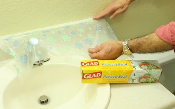 Apply Glad Press'n Seal to a bathroom counter for paint protection