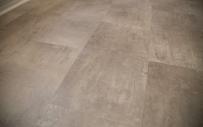 Close-up view of tan/gray luxury vinyl tile