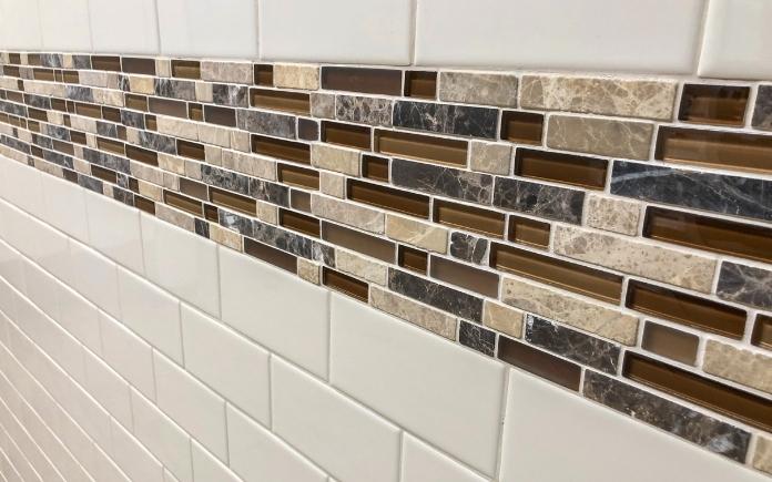 Multi-colored accent tile in white subway tile