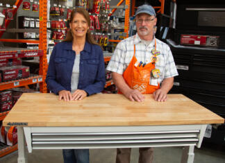 “Today’s Homeowner” Best New Products host Jodi Marks, pictured with a Husky adjustable height workbench along with Dan Levinson at the Home Depot in Mobile, Alabama.