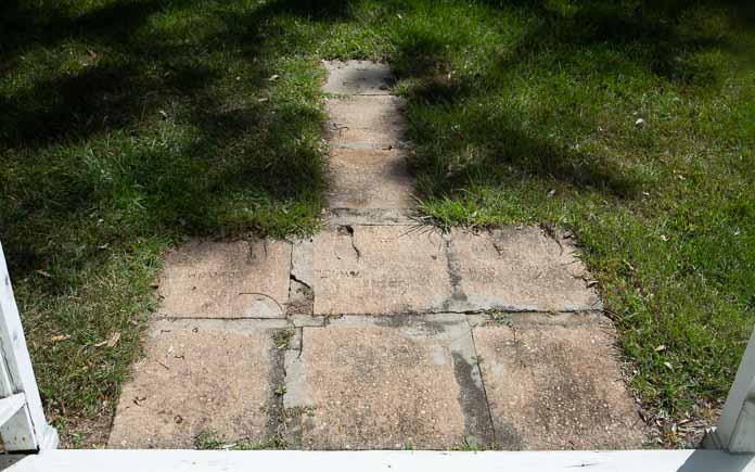 Concrete squares form an incomplete walkway in a yard