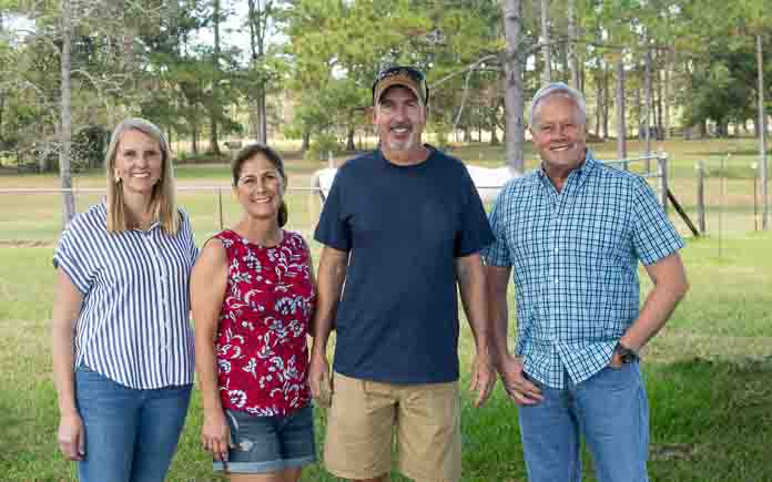 Today's Homeowner TV Host Danny Lipford and Co-Host Chelsea Lipford Wolf pose for a picture with homeowners Michael and Leigh Ann Riley.