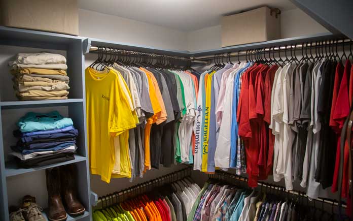 Custom closet system with cubby shelves and double horizontal rods to hang shirts