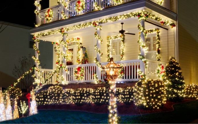 Traditional, Victorian-style home decorated with holiday lights