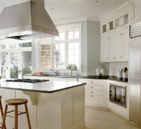 The kitchen blends new and old with stainless steel appliances and traditionally styled cabinets.