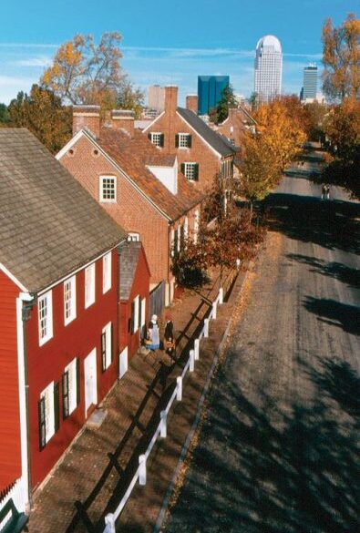 A historic streetscape in the village, with the Winston-Salem central business district in the background. (Photos: Courtesy Old Salem Museums & Gardens)
