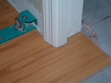 Installing the flooring around the door jam will take a few extra cuts, its easiest to take the door off.